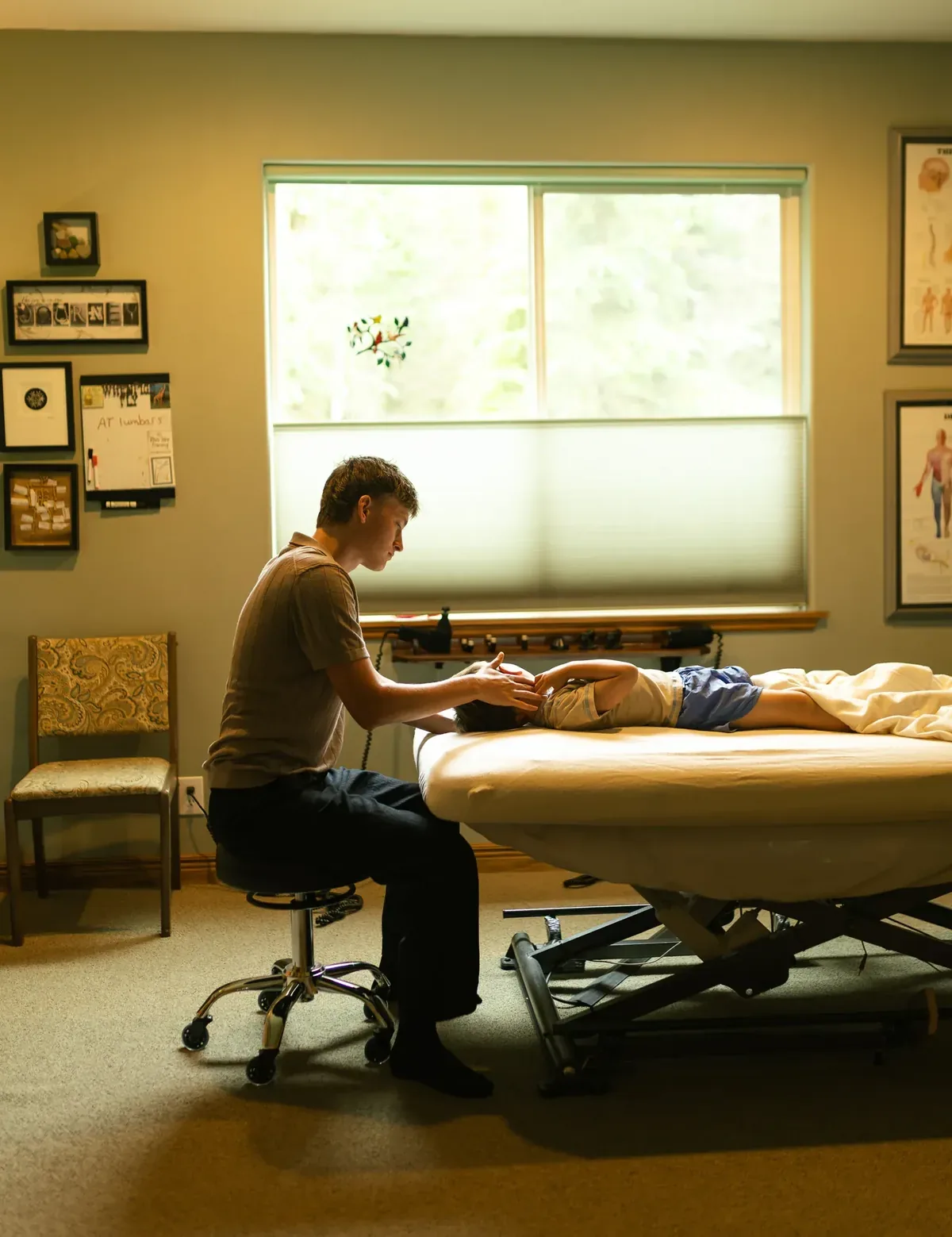 Rolfing session in Soldotna, Alaska — practitioner working with client at the table